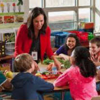 Young student with teacher in classroom