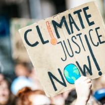 Sign saying climate justice now