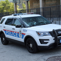 White SUV police vehicle with red and blue on the side saying POLICE