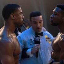 Two fighters facing off in the ring with ref between them