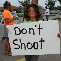 Boy holds sign that says Don't Shoot