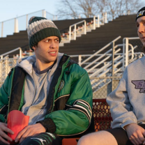 Two guys sitting outside 