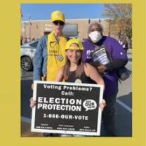 People posing with Election Protection sign