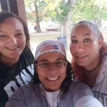 Three women including Esther in the middle