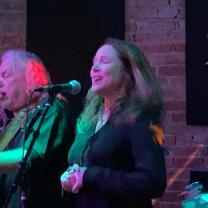 Woman singing at a mic