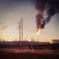 Smoking smokestacks and electrical poles with wires