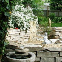 White stone fountain and pretty landscaping