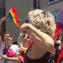 People dancing and a rainbow flag flying