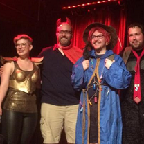 Four people dressed in geeky costumes