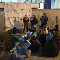 People protesting and sign saying Portman why don't you Fight4her