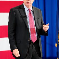 John Kasich in front of flag
