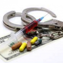 Handcuffs, a syringe, pills and a 100 dollar bill