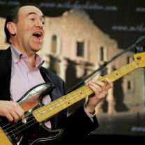 Mike Huckabee playing the bass guitar