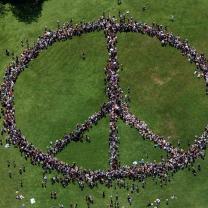 People standing as a peace sign from a distance