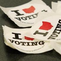 Stickers that say I, then a red silhouette of the state of Ohio that looks like a heart and then the word votng