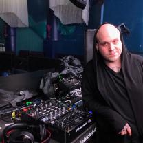 Man standing next to mixing board