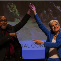 Ajamu and Jill holding up their hands in victory
