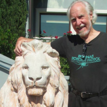 Jim Heddle standing next to a lion statue