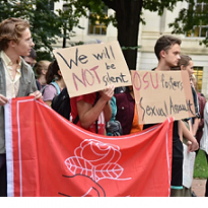 Young white people holding a big DSA sign marching