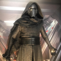 Guy in gold spacesuit looking outfit with helmet and facemask and hood from Star Wars