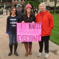 Three women holding sign that says Science Benefits Everyone