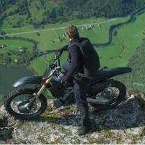 Man on a motorcycle on a cliff