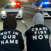 People protesting blocking police cars