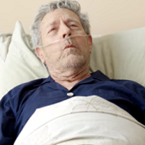 Old man with oxygen in his nose, in a bed