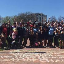 Students with fists in air on Oval