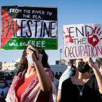From left to right, protest signs read: "From the river to the sea Palestine will be free", "End the occupation", "End apartheid."