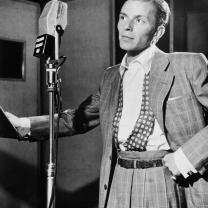 Black and white photo of young Frank Sinatra at the mic