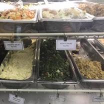 Lots of food in different trays all labeled