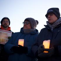 People outside holding candles