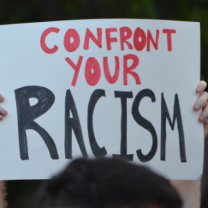 Sign saying confront your racism