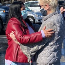 Miriam embracing another person