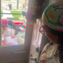 Looking out a window of women sleeping on the ground