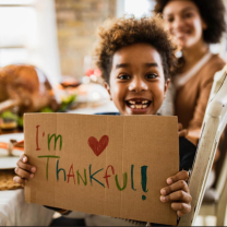 Little boy holding sign I'm Thankful
