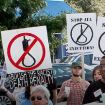People marching with signs that say Abolish the Death Penalty and Stop Executions