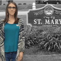 Woman standing next to St. Mary's sign