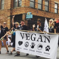 People marching with Vegan banner