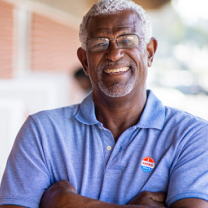 Man with voting sticker on shirt