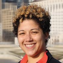 Head shot of young black woman with short curly hair smiling