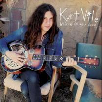 Guy with long hair playing guitar