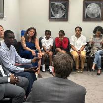 People sitting in a circle at a meeting