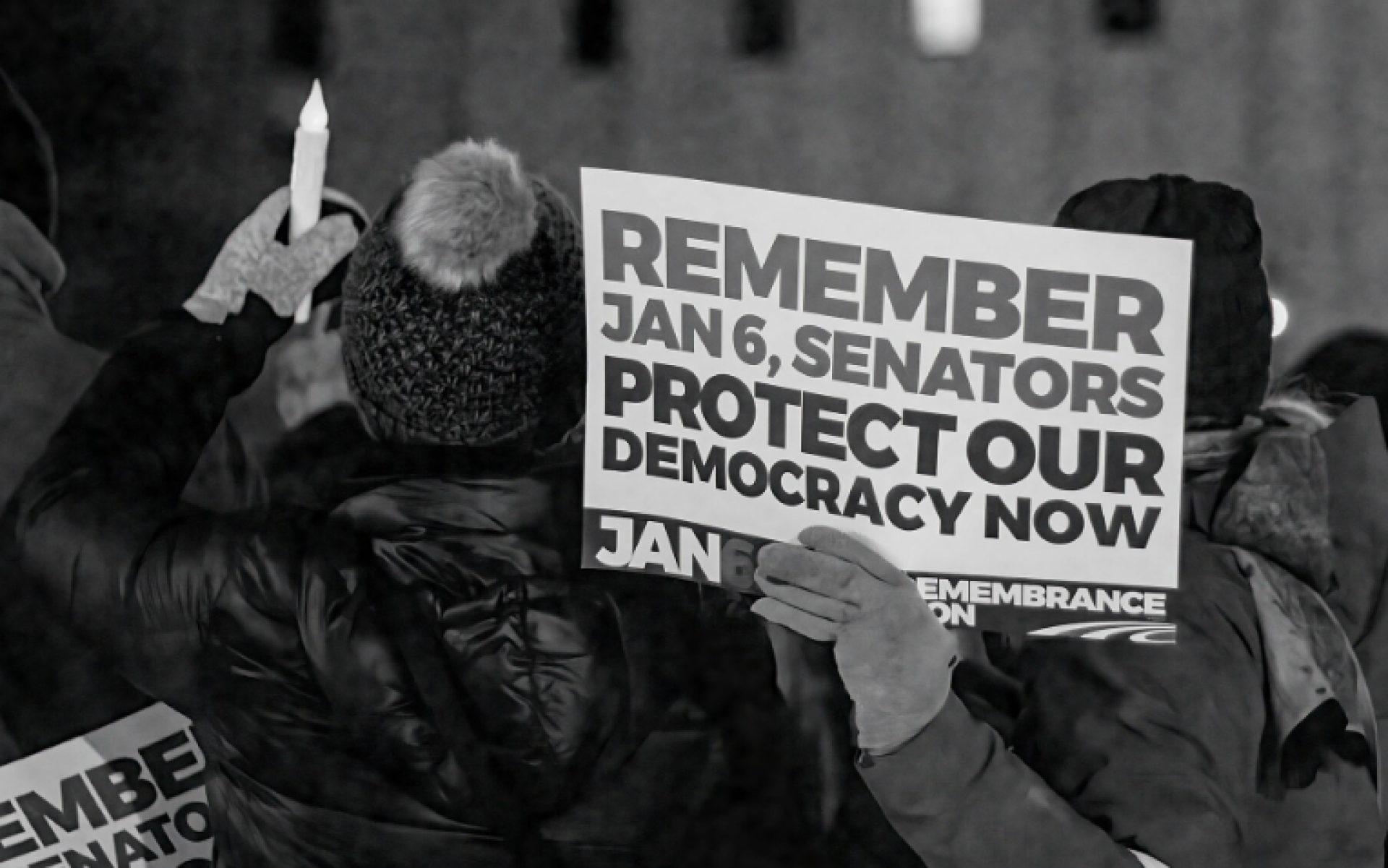 Protester hoding sign Protect our democracy now